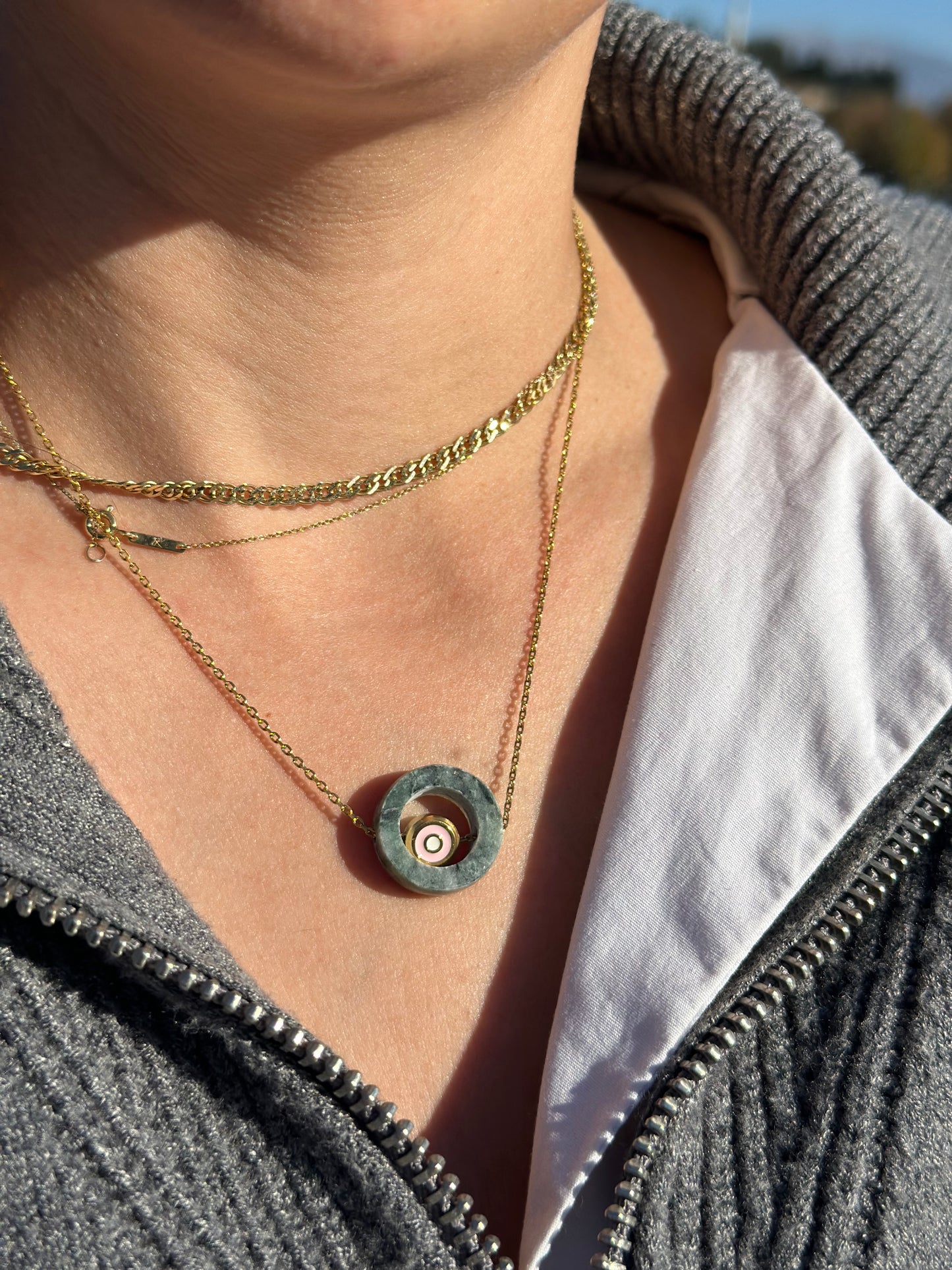 Circle made of green Tinos marble with an internal steel eyelet