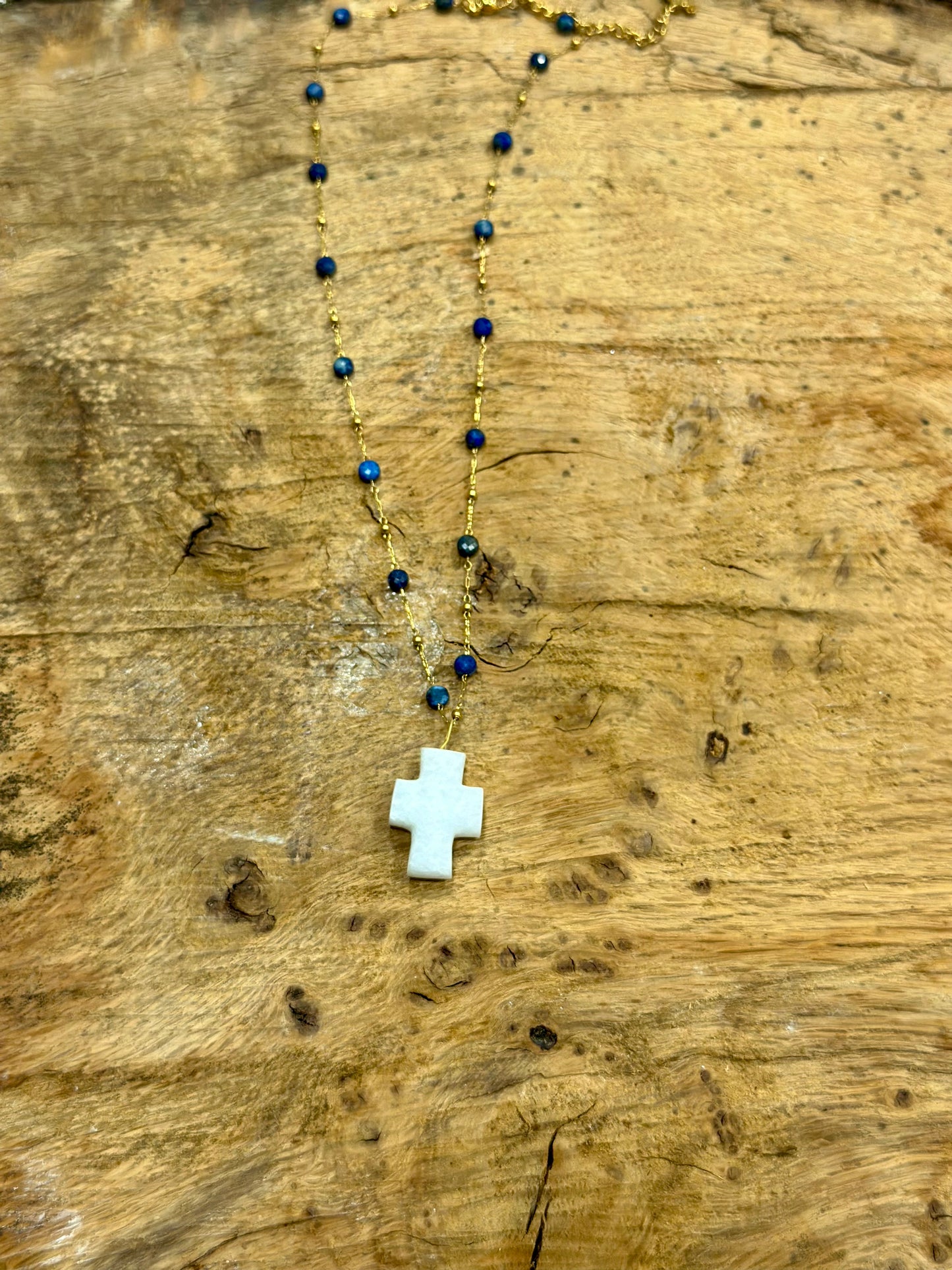 White marble crucifix with rosary chain