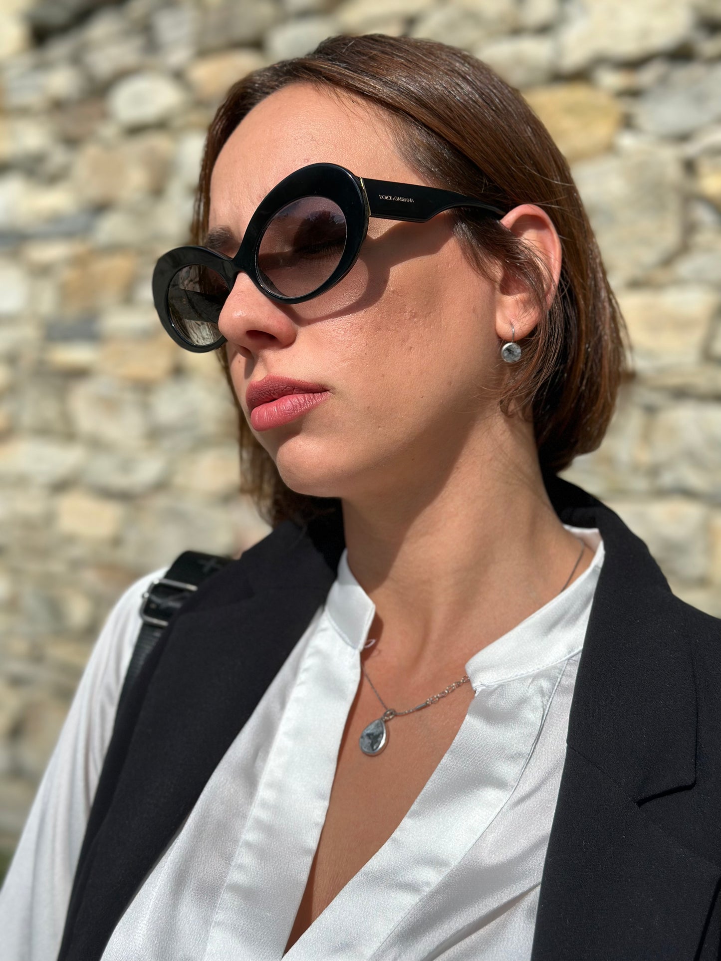 Round earrings in a gray granite setting