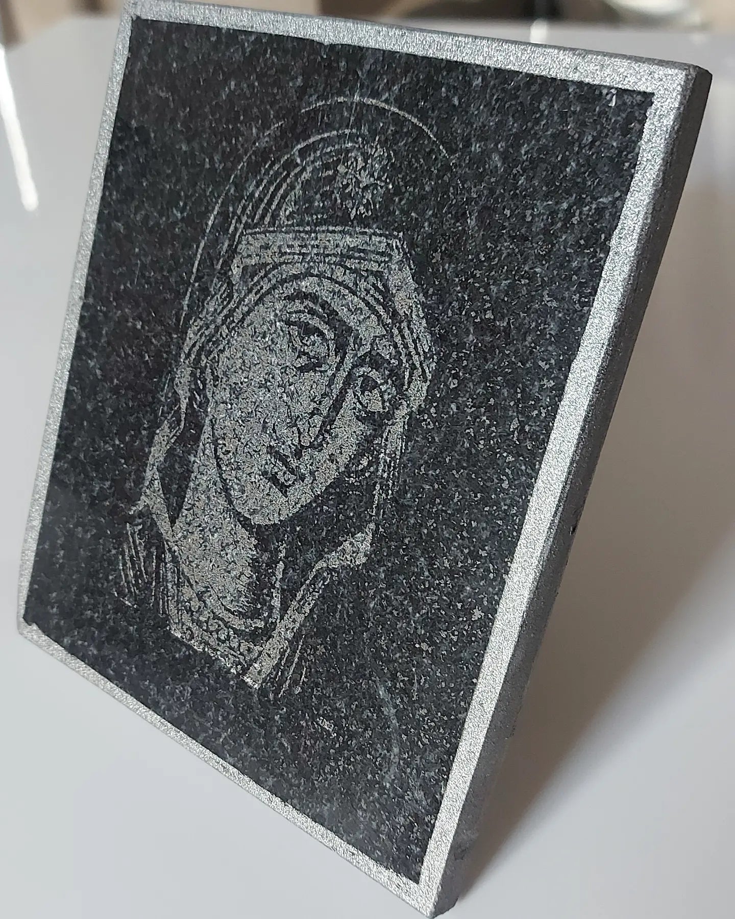 Icon of the Virgin Mary carved on black granite. Dimensions 12*15