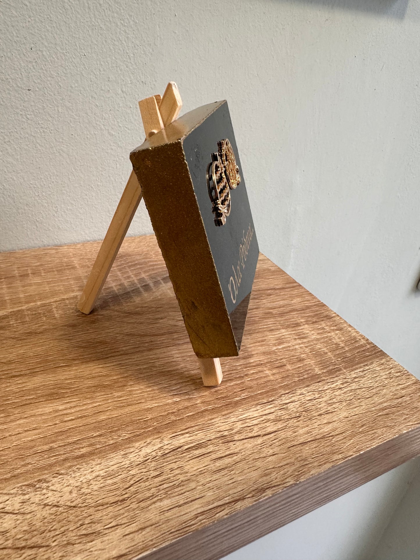 "All in Pink" charm, metal elements with pomegranate, engraving on black granite with gold letters and wooden base