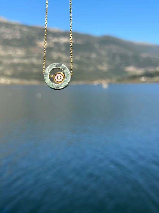 Circle made of green Tinos marble with an internal steel eyelet