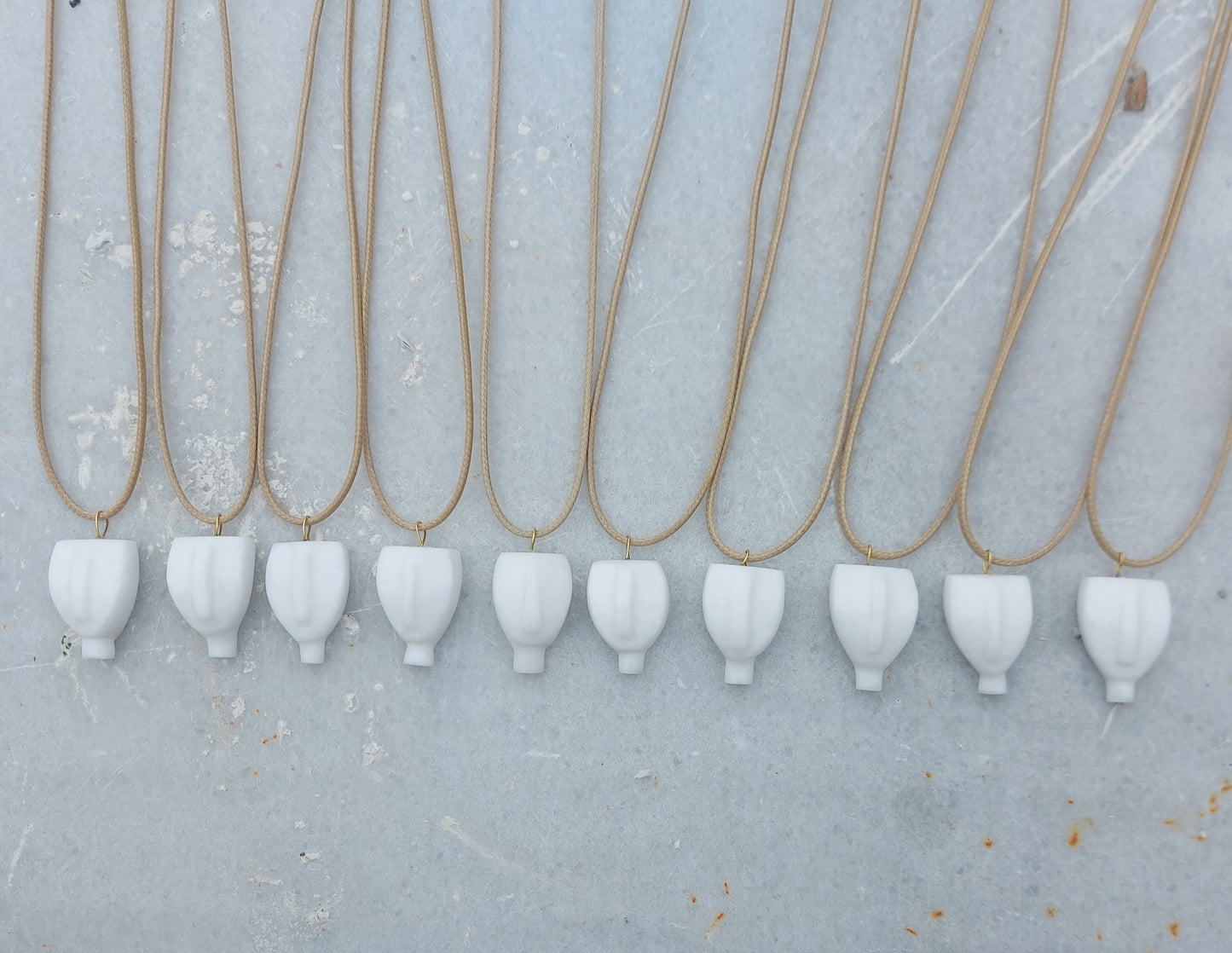 Cycladic figurine made of white marble with string