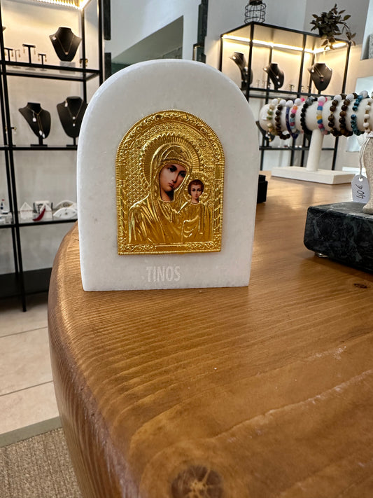 The Virgin Mary in a golden depiction on 3 cm thick white marble