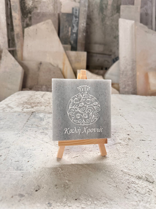 Pomegranate charm with good year designs engraved in marble with wooden base