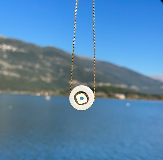 White marble circle with an internal square steel eyelet