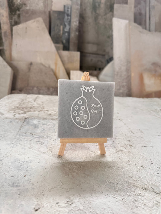Good luck pomegranate charm engraved in marble with wooden base