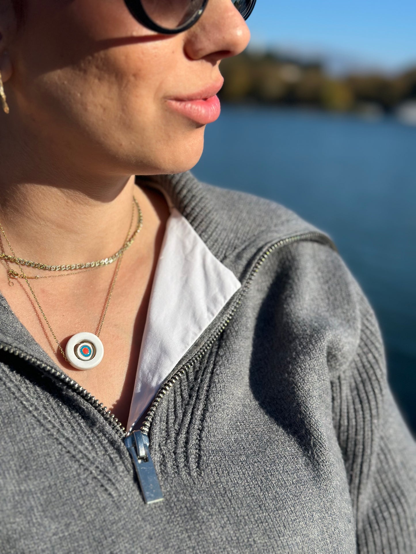 White marble circle with internal steel circular eyelet