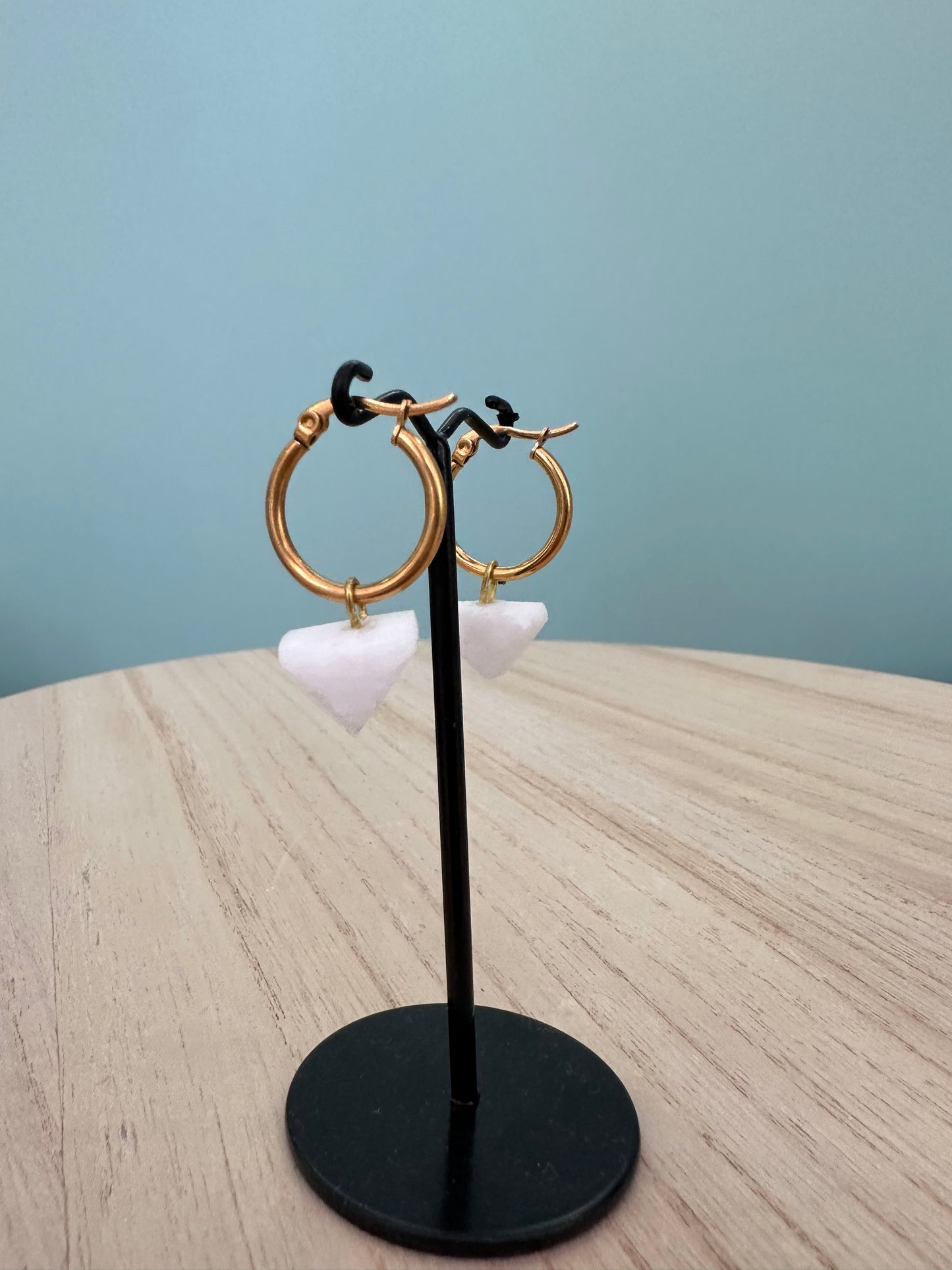 White marble earrings in a triangle shape with a circular steel clasp