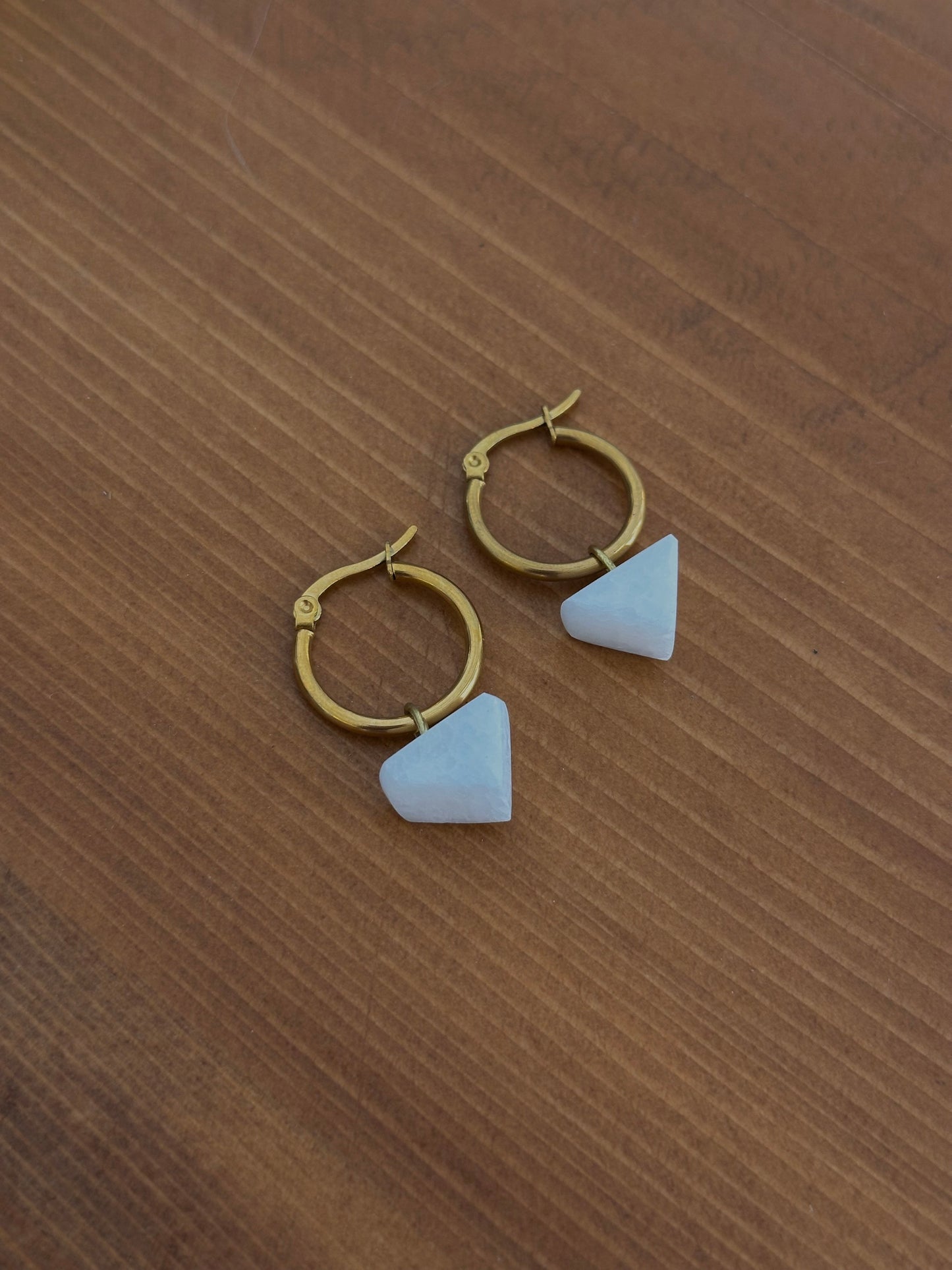 White marble earrings in a triangle shape with a circular steel clasp