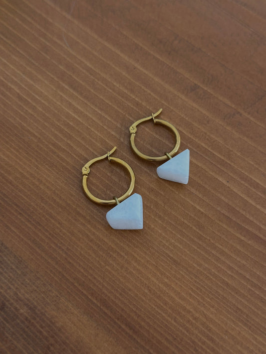White marble earrings in a triangle shape with a circular steel clasp