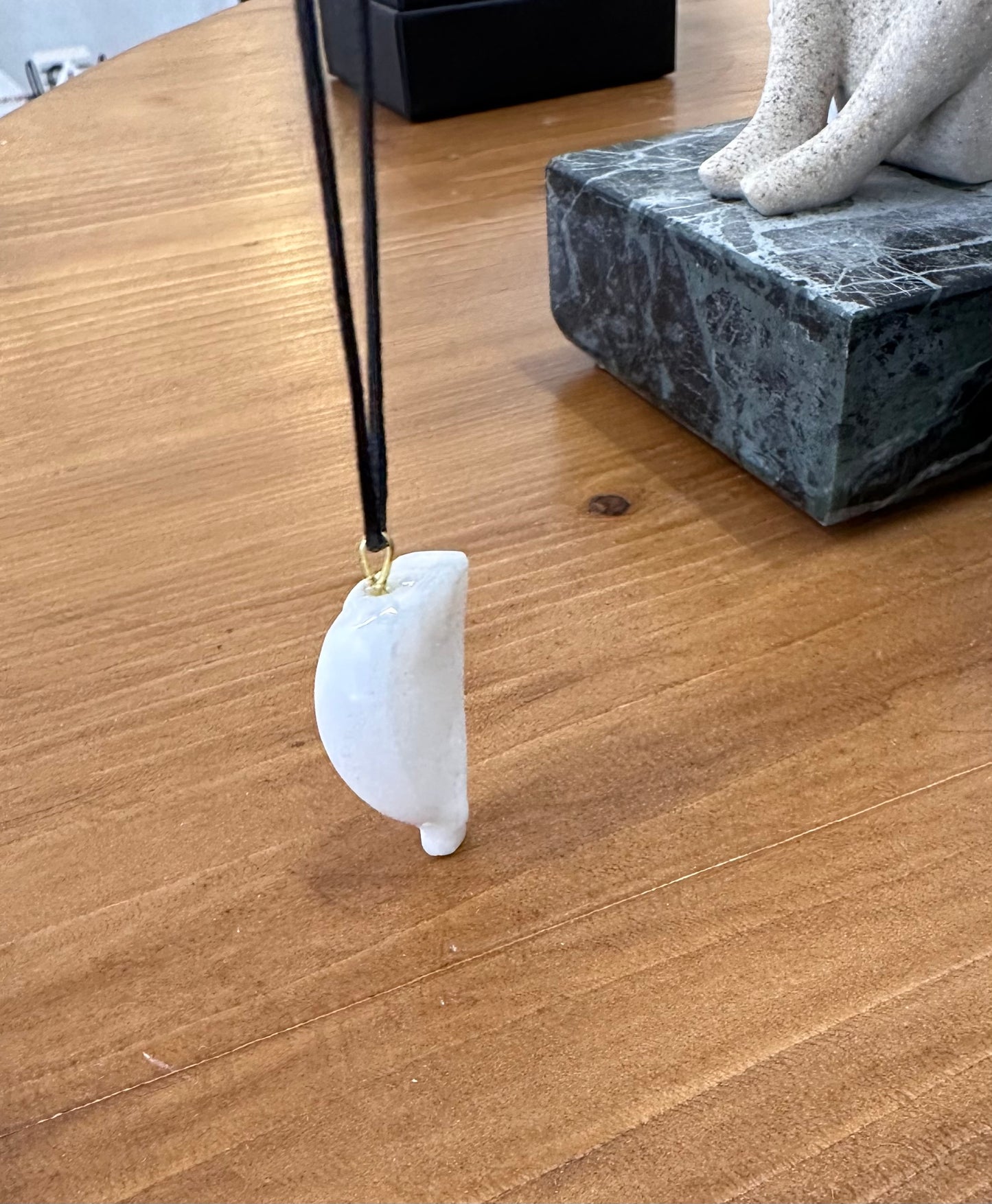 Cycladic figurine made of white marble with string