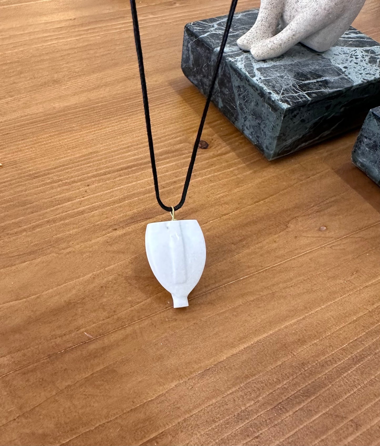 Cycladic figurine made of white marble with string