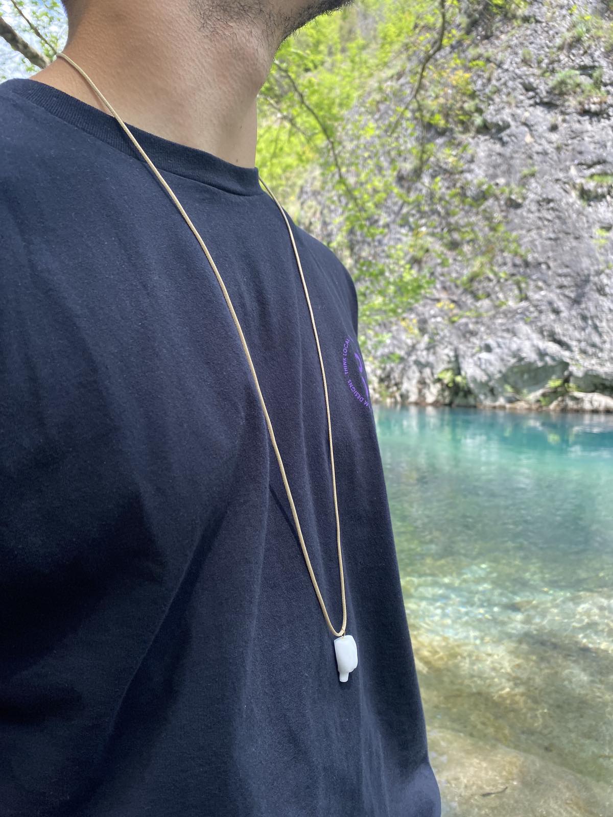 Cycladic figurine made of white marble with string