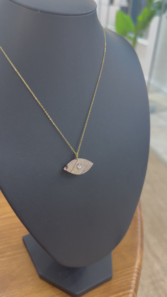 Brown eye-shaped marble with zircons