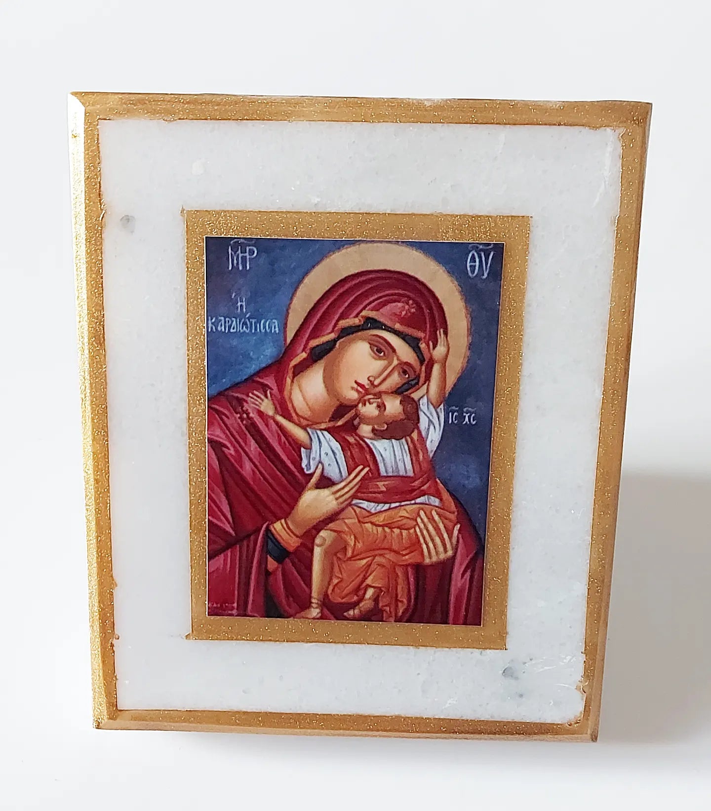 Icon of the Virgin Mary on white marble, gilded. Dimensions 12*15